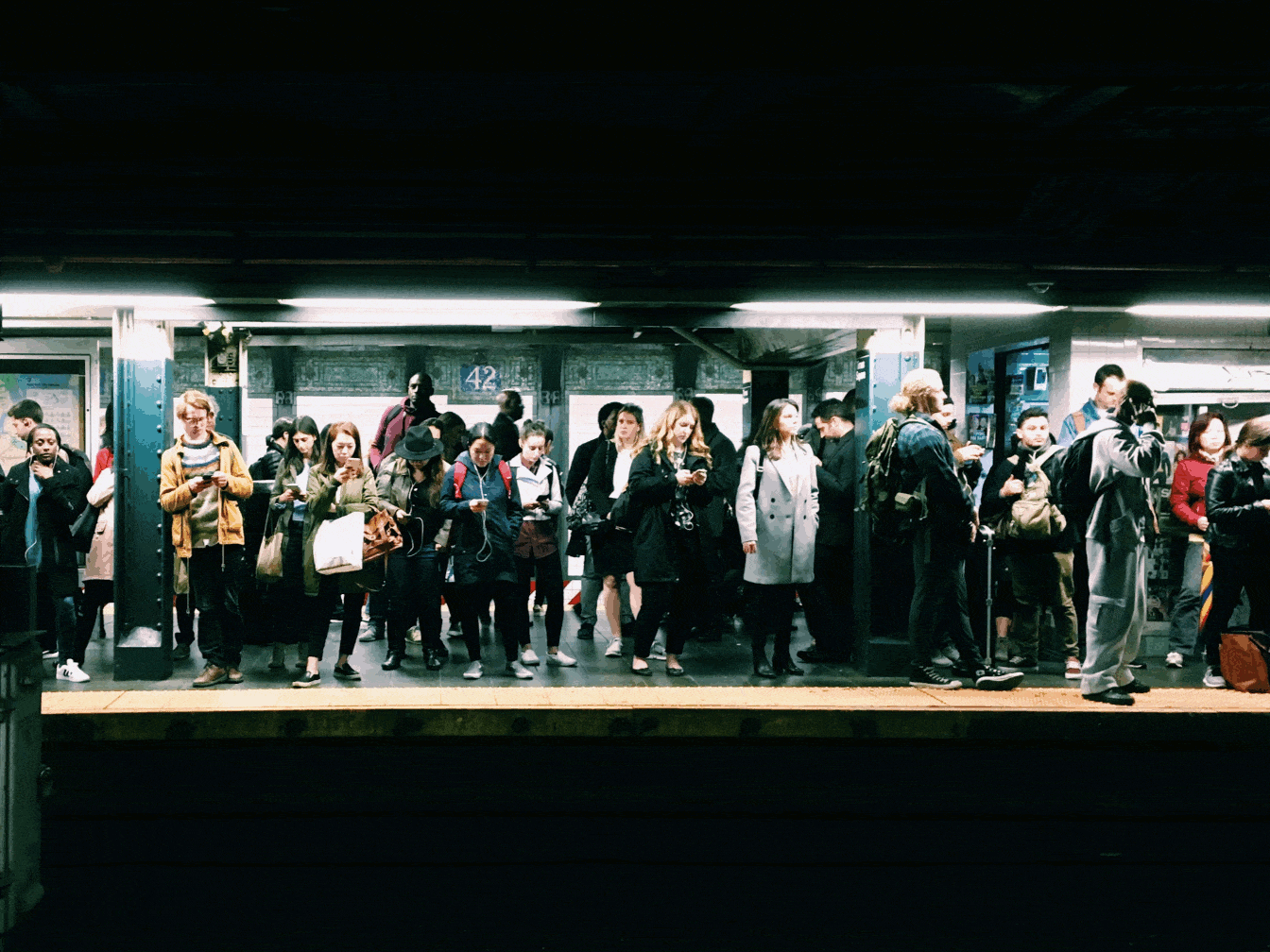 Person detection boxes drawn over a crowded station platform